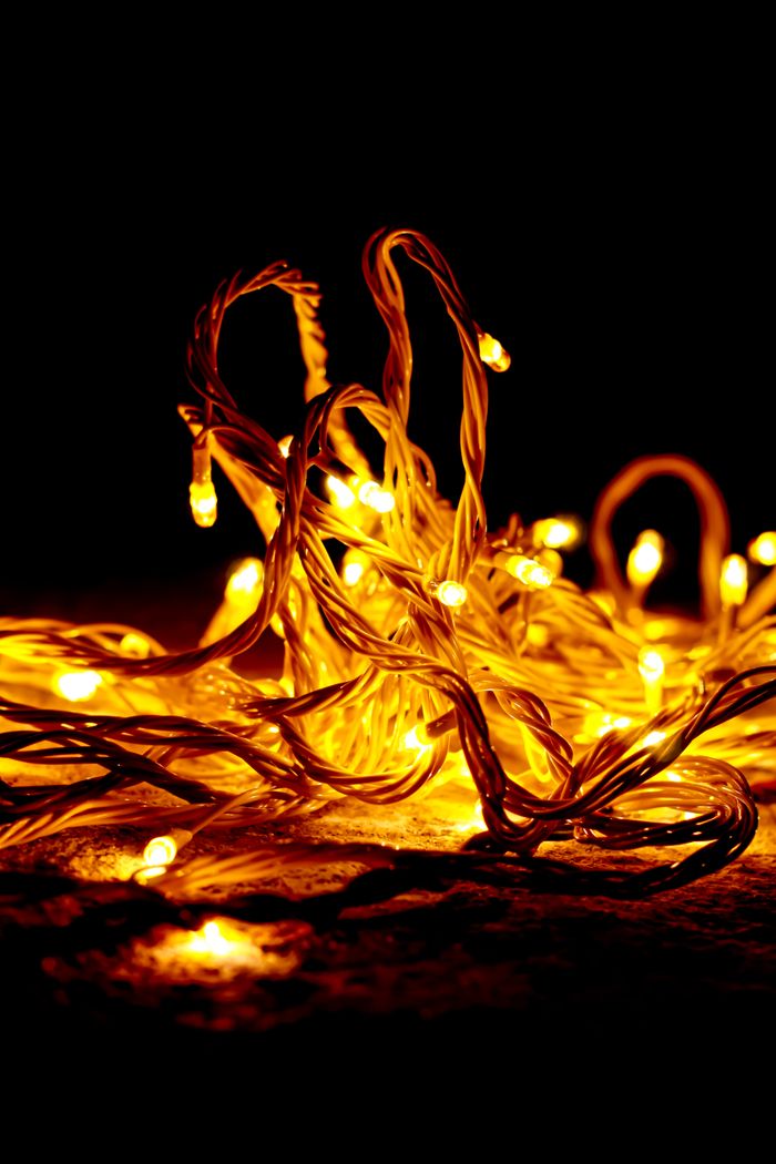 A glowing arrangement of yellow fairy lights against a dark background.