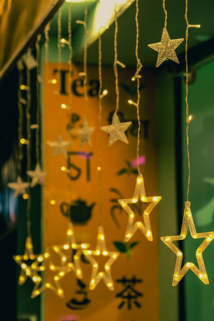 Glowing star-shaped lights create a festive winter ambiance on city streets, perfect for Christmas decoration.