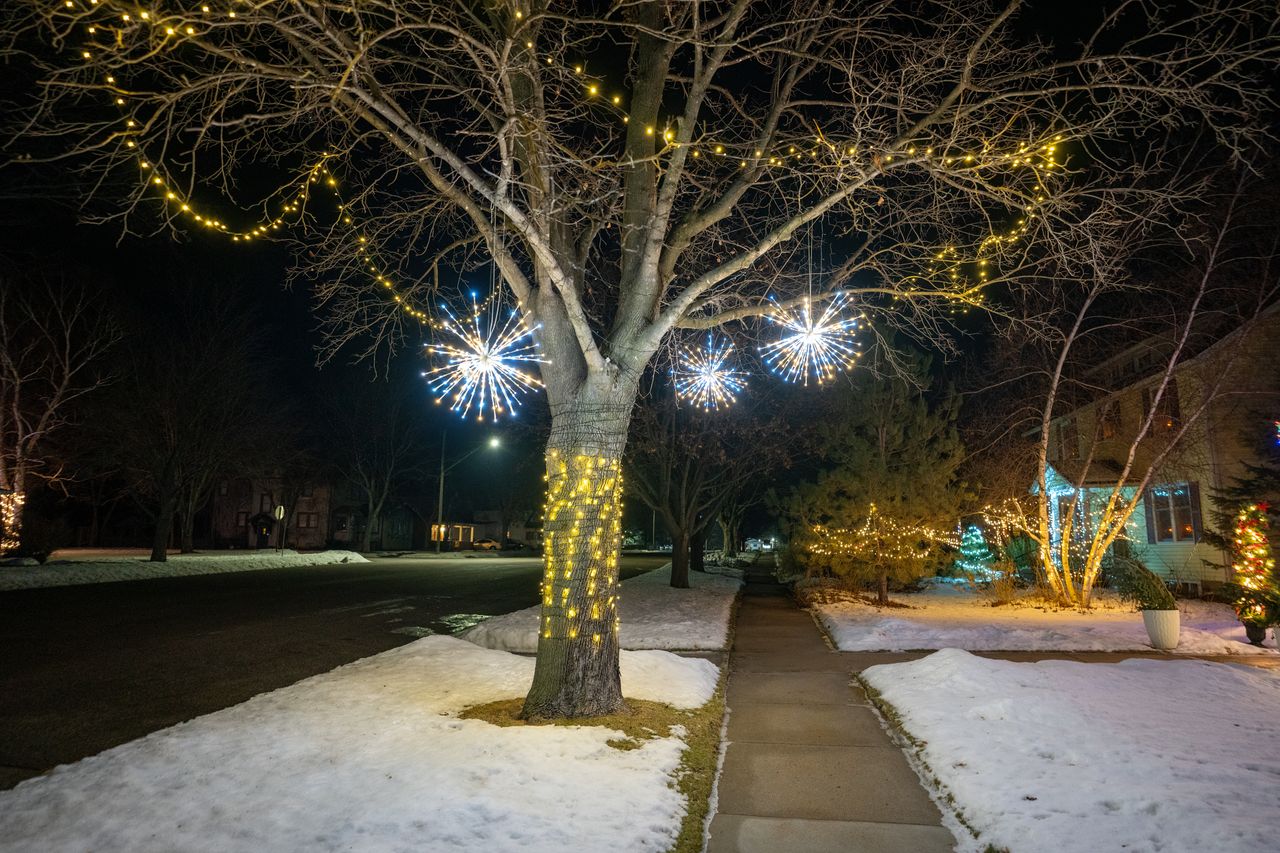 A snowy street in Wabasha, Minnesota, adorned with glowing winter lights. Perfect winter night scene.